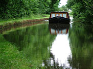 A not so narrow boat approaching Farnhill Wood