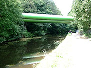 Two huge pipes traverse the canal