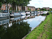 Moored boats and canalside apartments