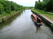 A barge leaves lock 2 and heads towards Leigh