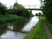 A narrow footbridge crosses the canal