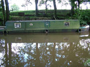 A mucky narrow boat, looks like it has been there a while