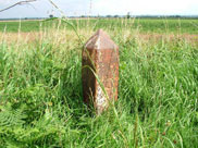 Old and weathered mileage marker