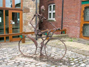 Sculpture of man on bicycle
